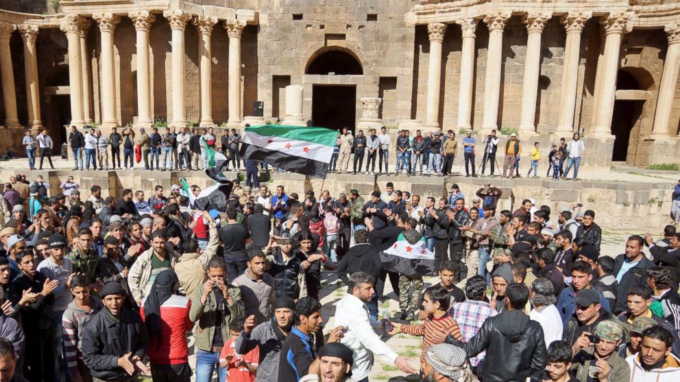 PHOTO: Protesters carry opposition flags and chant slogans during an anti-government protest inside a 2nd century Roman amphitheater in the historic Syrian southern town of Bosra al-Sham, in Deraa, Syria, March 4, 2016.