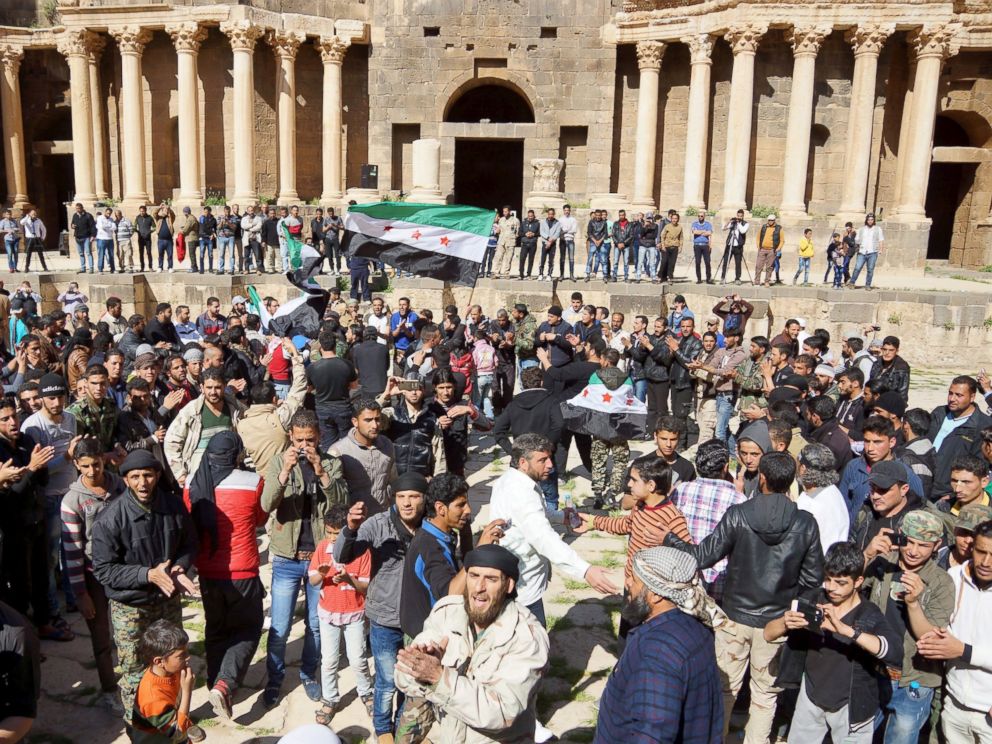 PHOTO: Protesters carry opposition flags and chant slogans during an anti-government protest inside a 2nd century Roman amphitheater in the historic Syrian southern town of Bosra al-Sham, in Deraa, Syria, March 4, 2016.