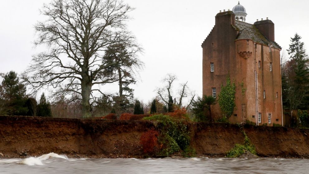 The river Dee flows very close to Abergeldie Castle after a section of land was washed away by the flood swollen river in Scotland, Jan. 4, 2016. 
