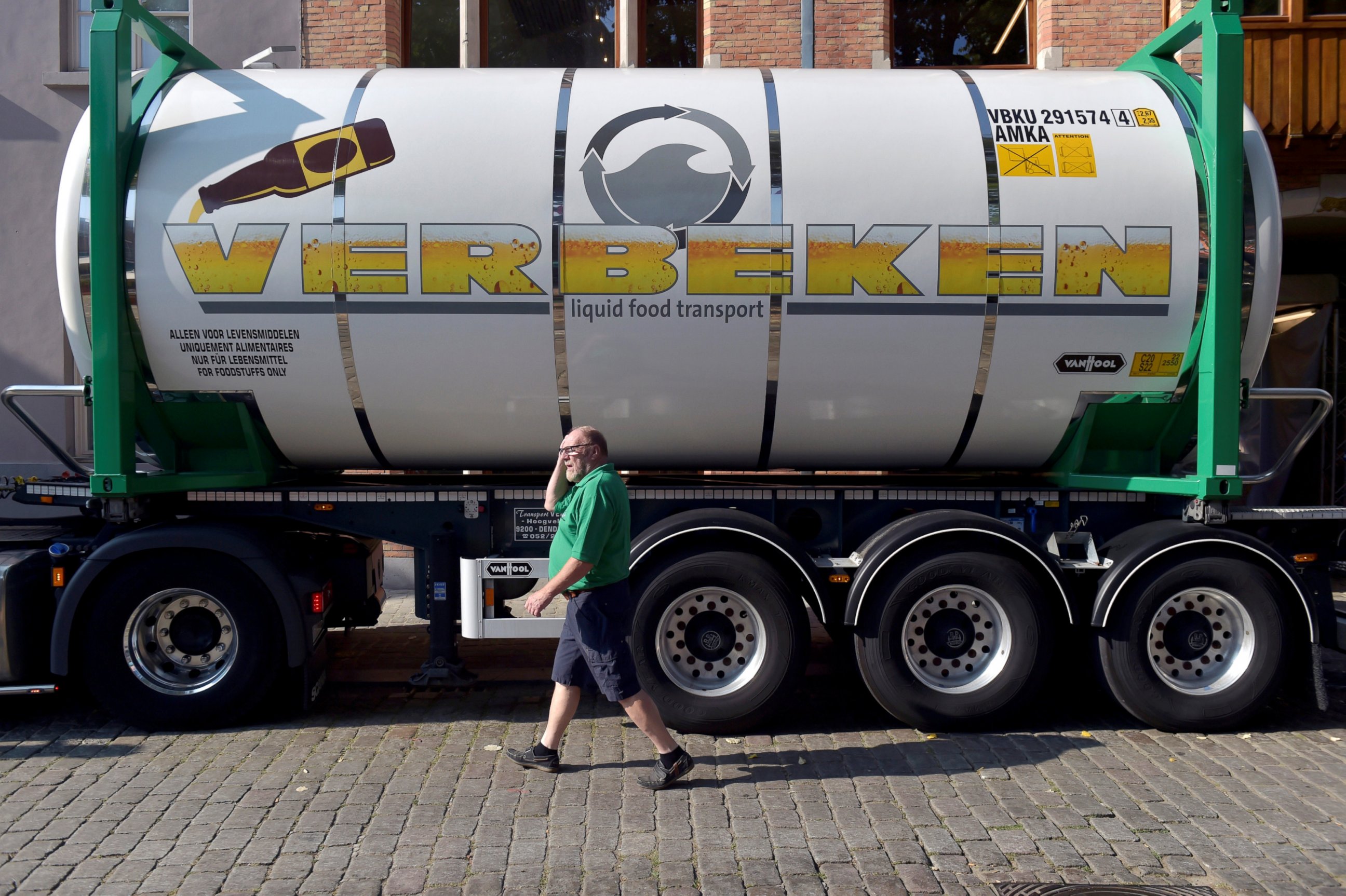PHOTO: A driver walks near his truck as he collects beer from De Halve Maan brewery in Bruges, Belgium, Sept. 15, 2016.  