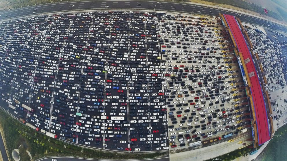 Vehicles are seen stuck in a traffic jam near a toll station as people return home at the end of a week-long national day holiday, in Beijing, Oct. 6, 2015. 