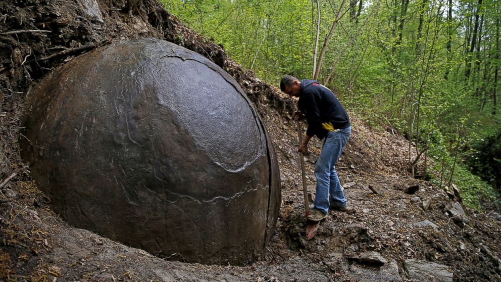 PHOTO: Suad Keserovic cleans a stone ball in Podubravlje village near Zavidovici, Bosnia and Herzegovina, April 11, 2016. 