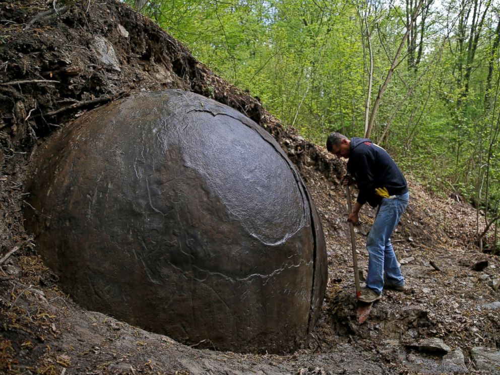 PHOTO: Suad Keserovic cleans a stone ball in Podubravlje village near Zavidovici, Bosnia and Herzegovina, April 11, 2016.