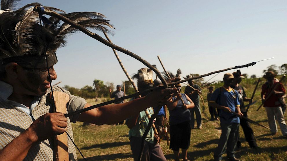 Brazilian Indians of the Guarani-Kaiowa tribe, group together as they invade a private ranch that they consider part of their "tekoha," or sacred land, in Paranhos, Mato Grosso do Sul state, Sept. 4, 2012.
