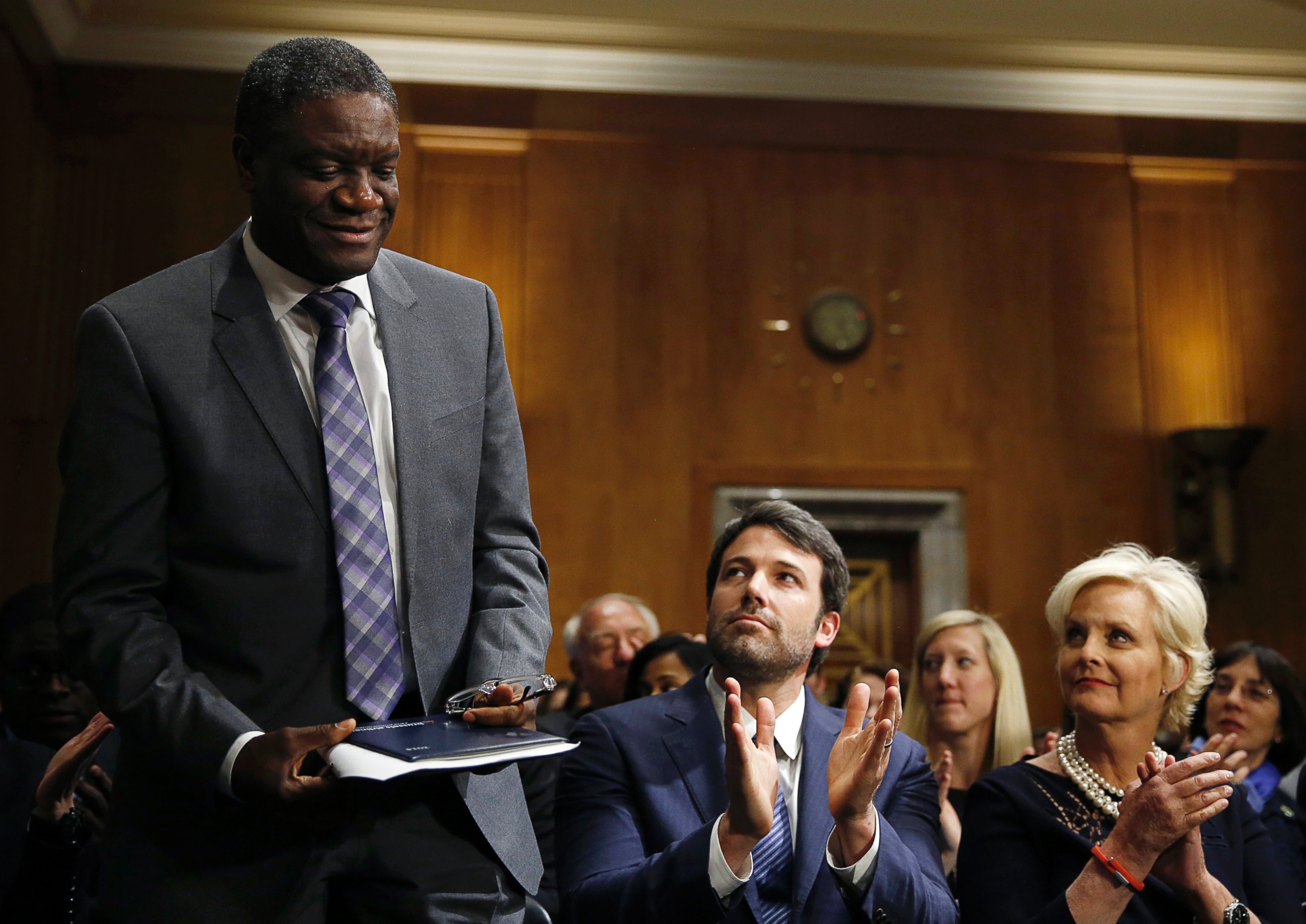 PHOTO: Actor, writer and director Ben Affleck (C) and Cindy McCain (L), applaud Denis Mukwege, (L), Medical Director of the Panzi Hospital in the Congo, at the Senate Foreign Relations Committee on Capitol Hill in Washington Feb. 26, 2014.