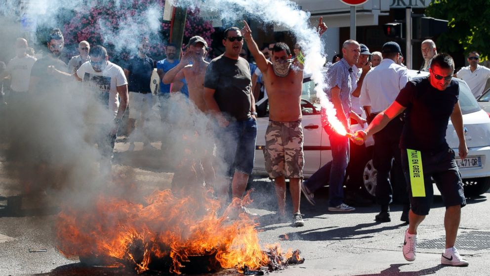 Taxi drivers on strike burn tires during a national protest against car-sharing service Uber in Marseille, France, June 25, 2015.