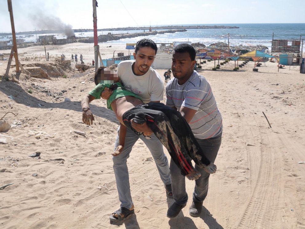 PHOTO: Palestinians carry the body of a boy whom medics said was killed by in Gaza City