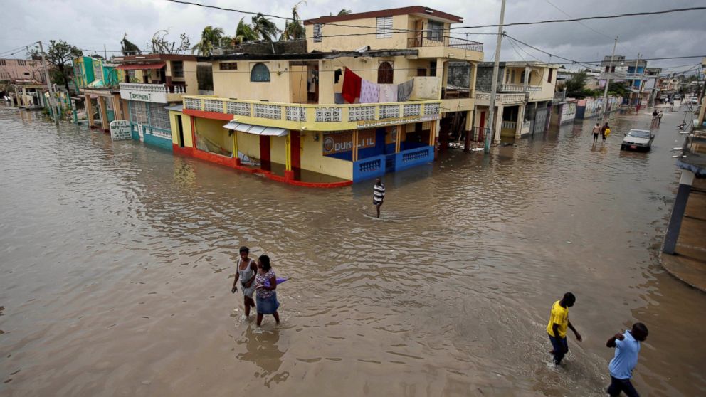 People walk in a flooded area after Hurricane Matthew in Les Cayes, Haiti, Oct. 5, 2016. 