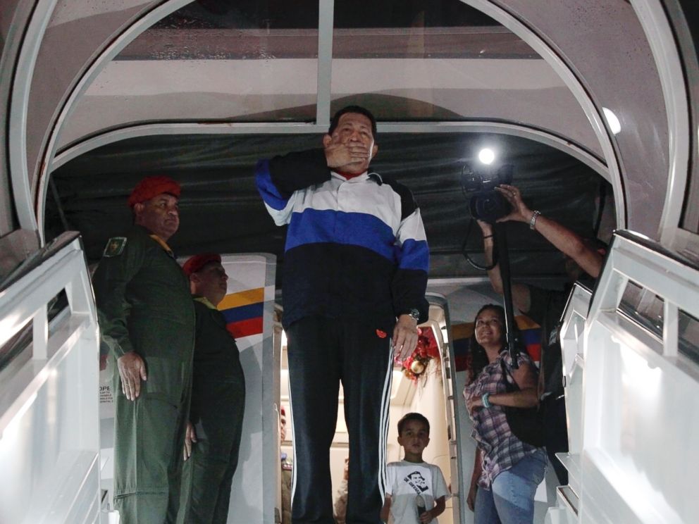 PHOTO: Venezuelan President Hugo Chavez blows a kiss from the door of the airplane before departing to Cuba at Simon Bolivar airport in Caracas, Dec. 10, 2012.
