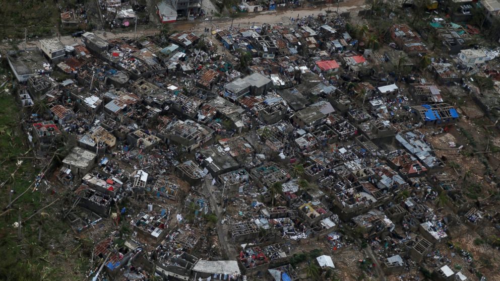 PHOTO: People walk around near destroyed houses after Hurricane Matthew passes Jeremie, Haiti, Oct. 5, 2016.