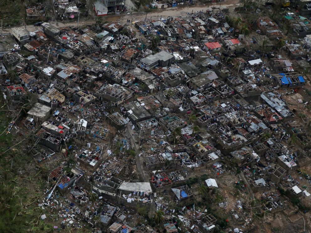 PHOTO: People walk around near destroyed houses after Hurricane Matthew passes Jeremie, Haiti, Oct. 5, 2016.