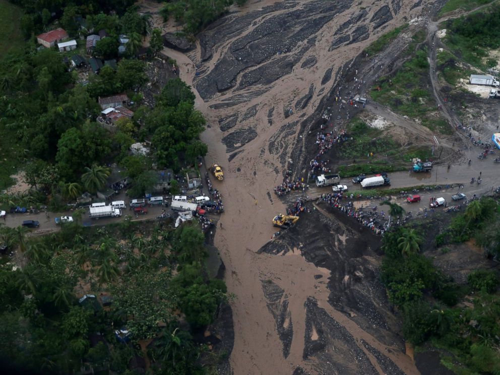 PHOTO: People gather next to a collapsed bridge after Hurricane Matthew passes Petit Goave, Haiti, Oct. 5, 2016.