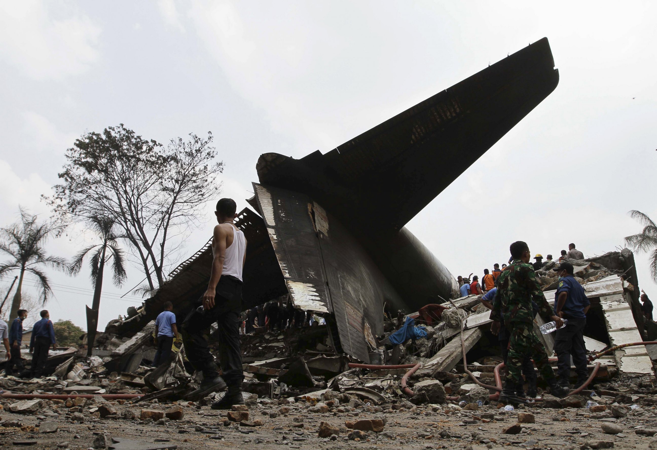 PHOTO: Security forces and rescue teams examine the the wreckage of an air force cargo plane that crashed in Medan, North Sumatra, Indonesia, June 30, 2015.