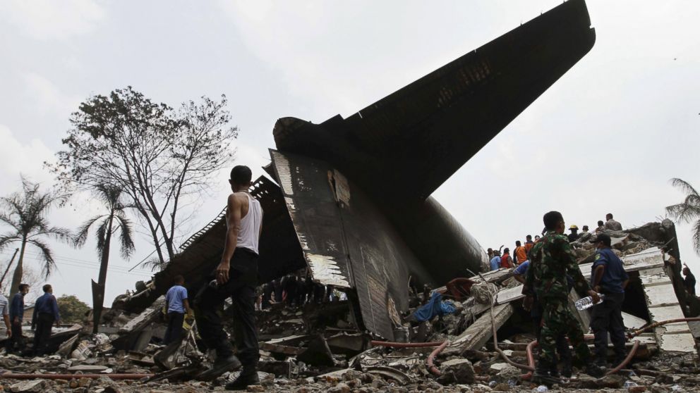 PHOTO: Security forces and rescue teams examine the the wreckage of an air force cargo plane that crashed in Medan, North Sumatra, Indonesia, June 30, 2015.