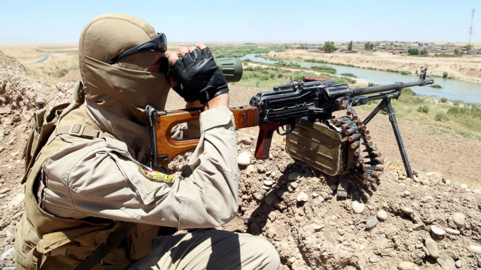 A member of Kurdish security forces takes his position during an intensive security deployment looking for militants of the Islamic State of Iraq and the Levant (ISIL), on the outskirts of Mosul, June 22, 2014.
