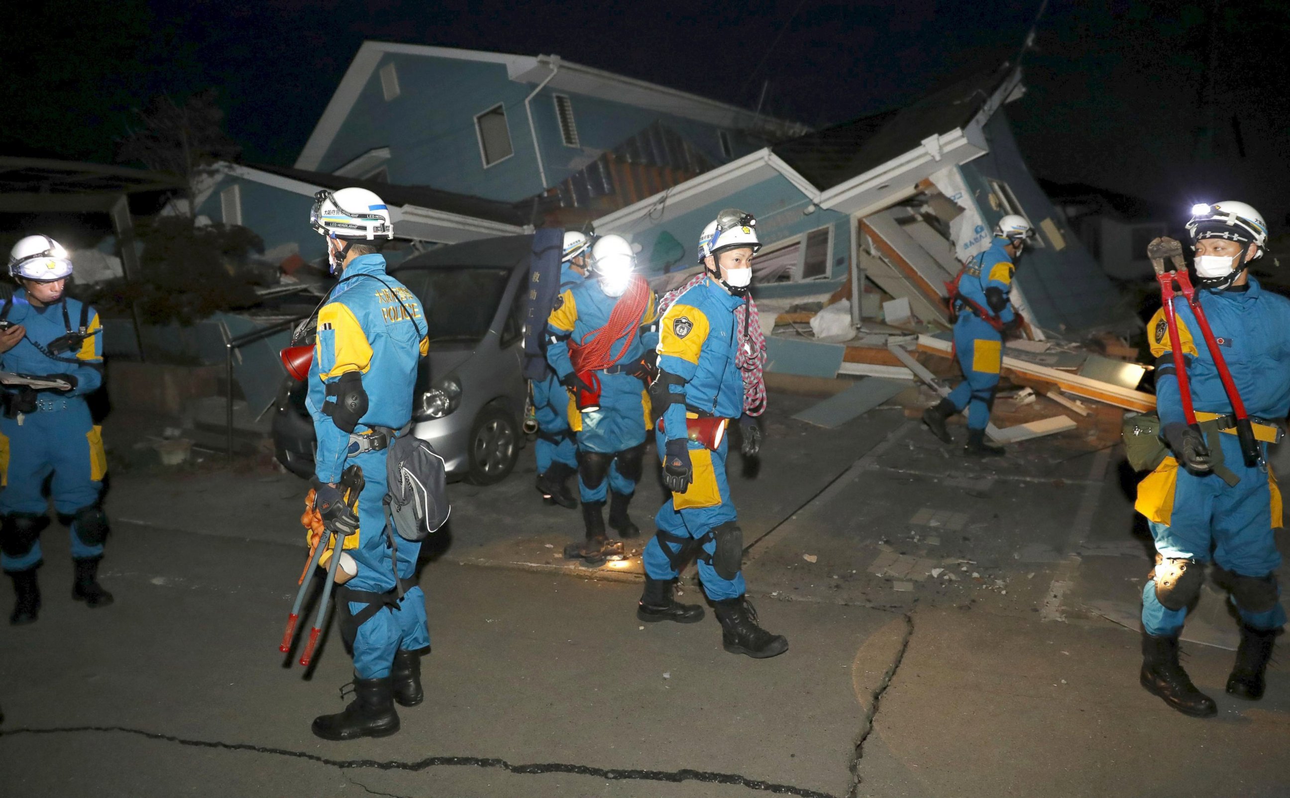PHOTO: Police officers check a collapsed house after an earthquake in Mashiki town, Kumamoto, Japan, April 16, 2016. 