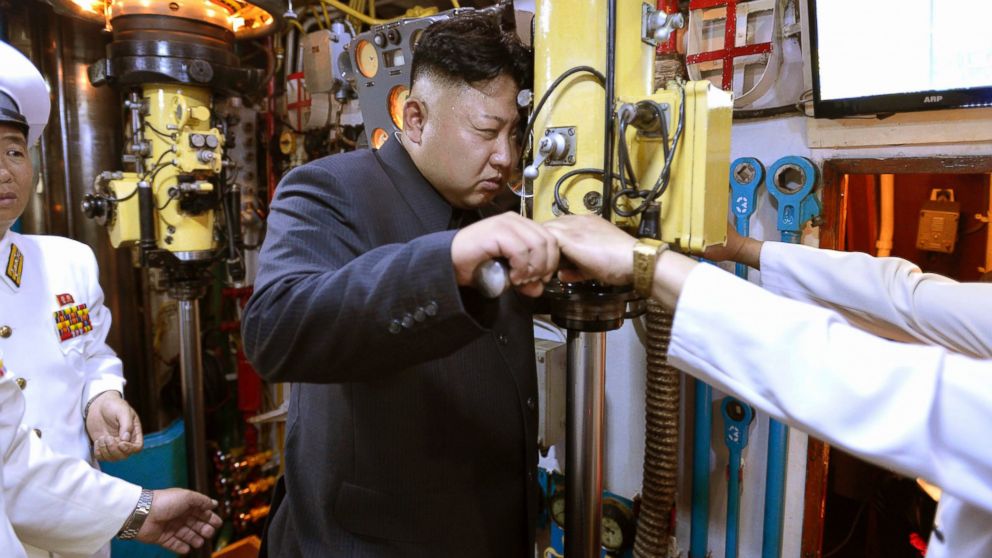 North Korean leader Kim Jong Un looks through a periscope of a submarine during his inspection of the Korean People's Army (KPA) Naval Unit 167 in this undated photo released by North Korea's Korean Central News Agency in Pyongyang, June 16, 2014. 