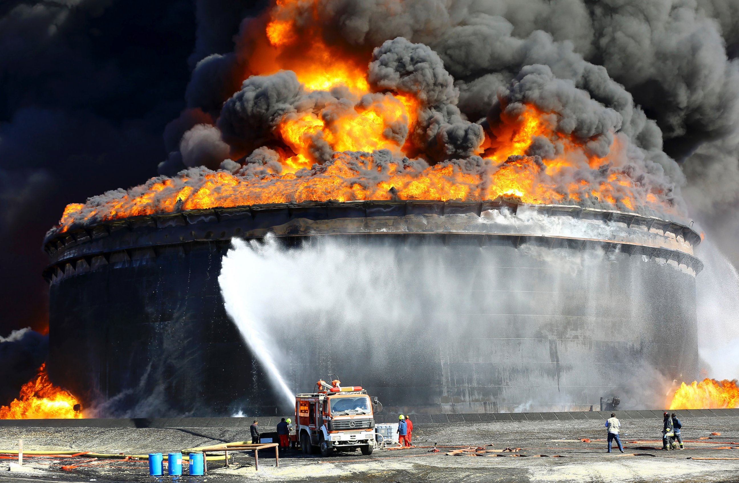 PHOTO: Firefighters work to put out the fire of a storage oil tank at the port of Es Sider in Ras Lanuf, Libya in this Dec. 29, 2014 file photo.