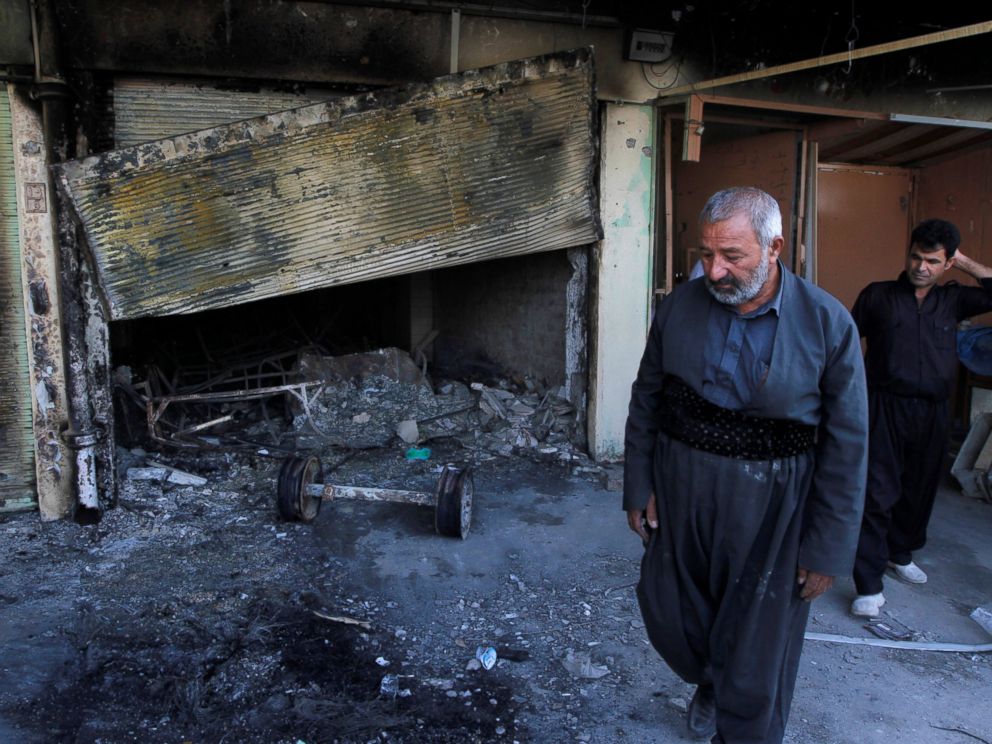 PHOTO: People inspect the damage after an attack by Islamic State militants in the city of Kirkuk, Iraq, Oct. 22, 2016.