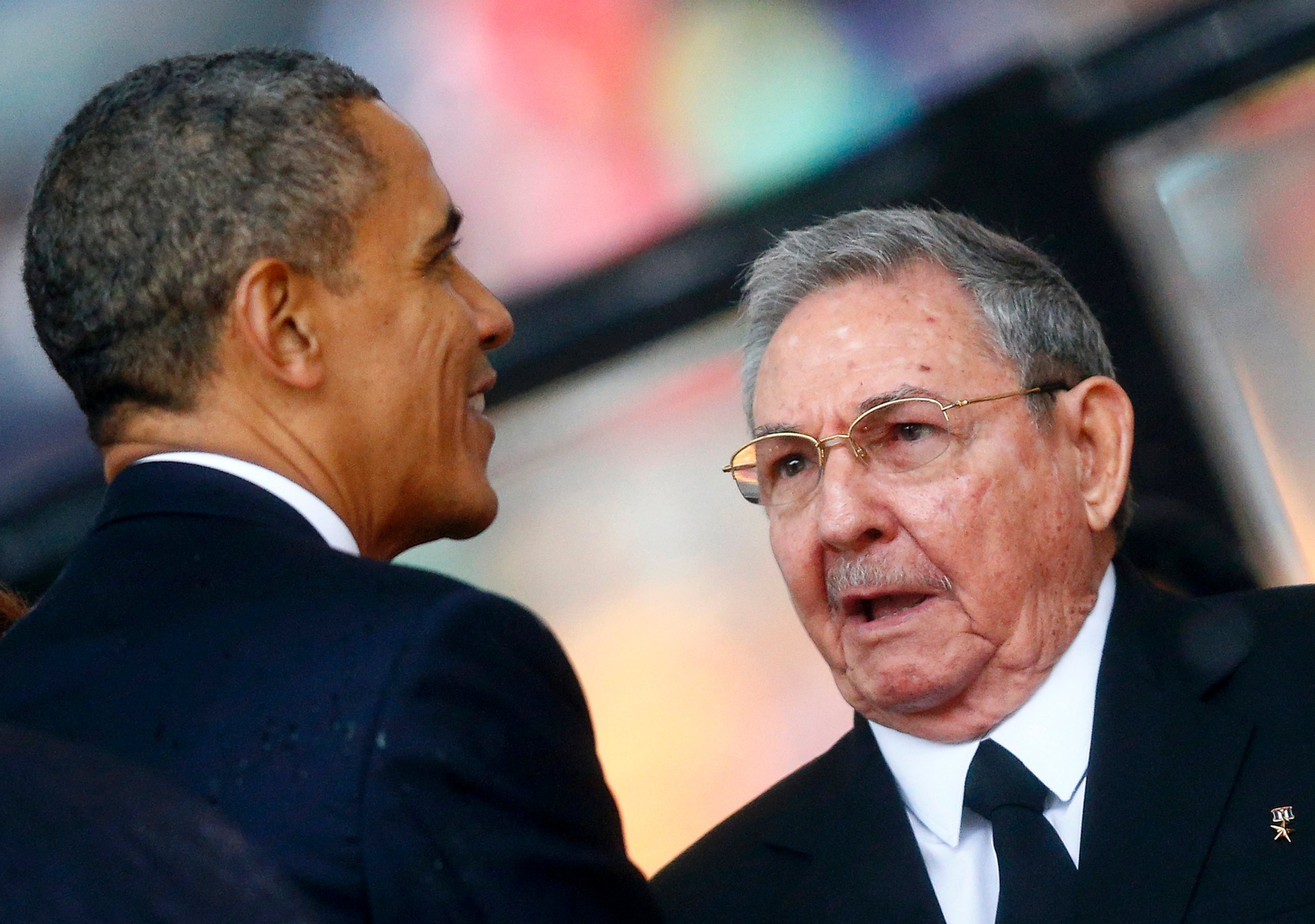 PHOTO: President Barack Obama greets Cuban President Raul Castro before giving his speech at the memorial service for Nelson Mandela at the First National Bank soccer stadium in Johannesburg, Dec. 10, 2013.