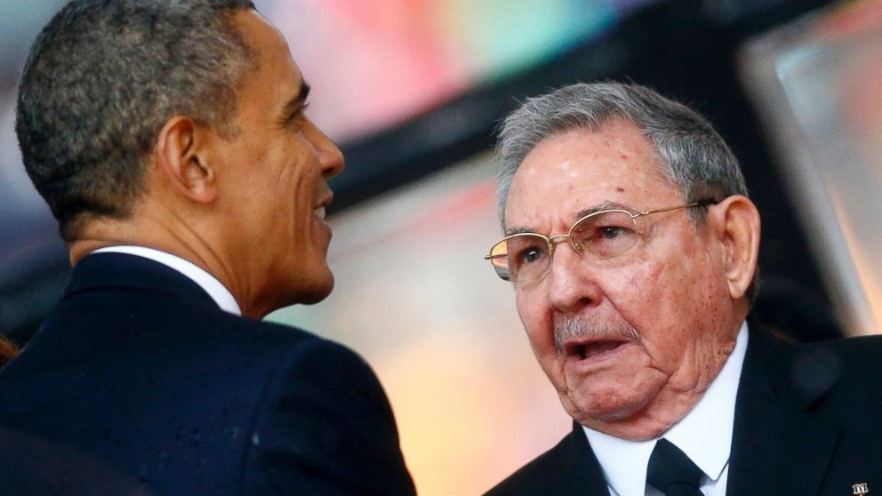 PHOTO: President Barack Obama greets Cuban President Raul Castro before giving his speech at the memorial service for Nelson Mandela at the First National Bank soccer stadium in Johannesburg, Dec. 10, 2013.