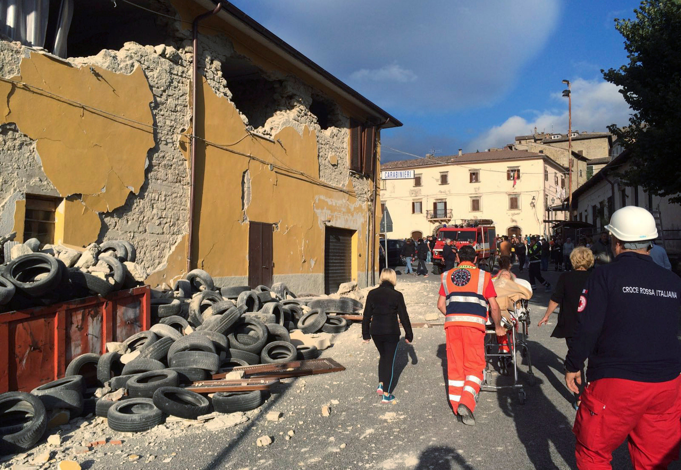 PHOTO: Rescuers and people walk along a road following an earthquake in Accumoli di Rieti, central Italy, Aug. 24, 2016.