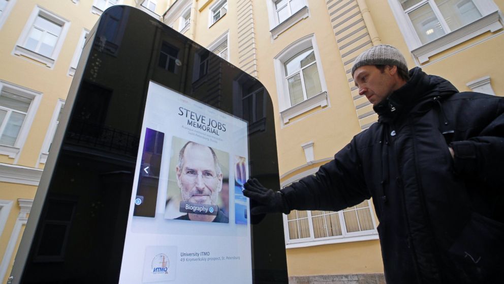 A man looks at a recently erected iPhone-shaped monument in memory of Apple's late co-founder Steve Jobs in the yard of the State University of Information Technologies, Mechanics and Optics in St. Petersburg, Jan. 10, 2013.