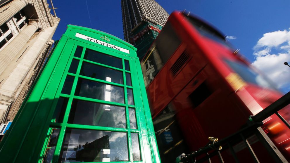 A bus passes a green "Solarbox" in central London, Oct. 3, 2014.