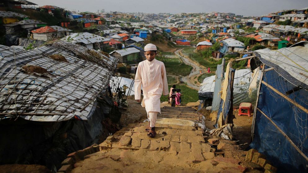A Rohingya boy walks toward a makeshift mosque to offer Eid al-Adha prayers at Kutupalong refugee camp, Bangladesh, Aug. 22, 2018. Hundreds of thousands of Rohingya refugees are celebrating Eid al-Adha in sprawling Bangladeshi camps where they have been living amid uncertainty over their future after they fled Myanmar to escape violence and a massive crackdown.