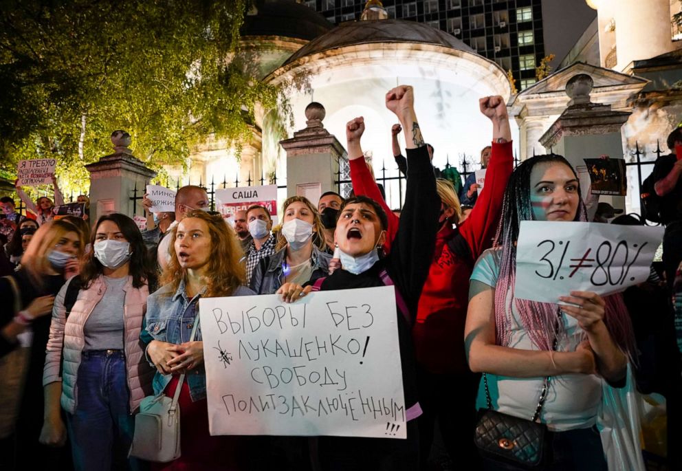 PHOTO: People hold a poster saying "Elections without Lukashenka! Freedom for political prisoners" and shout anti-Lukashenko slogans as they gather to support Belarusian opposition in front of Belarusian Embassy in Moscow Tuesday, Aug. 11, 2020.  