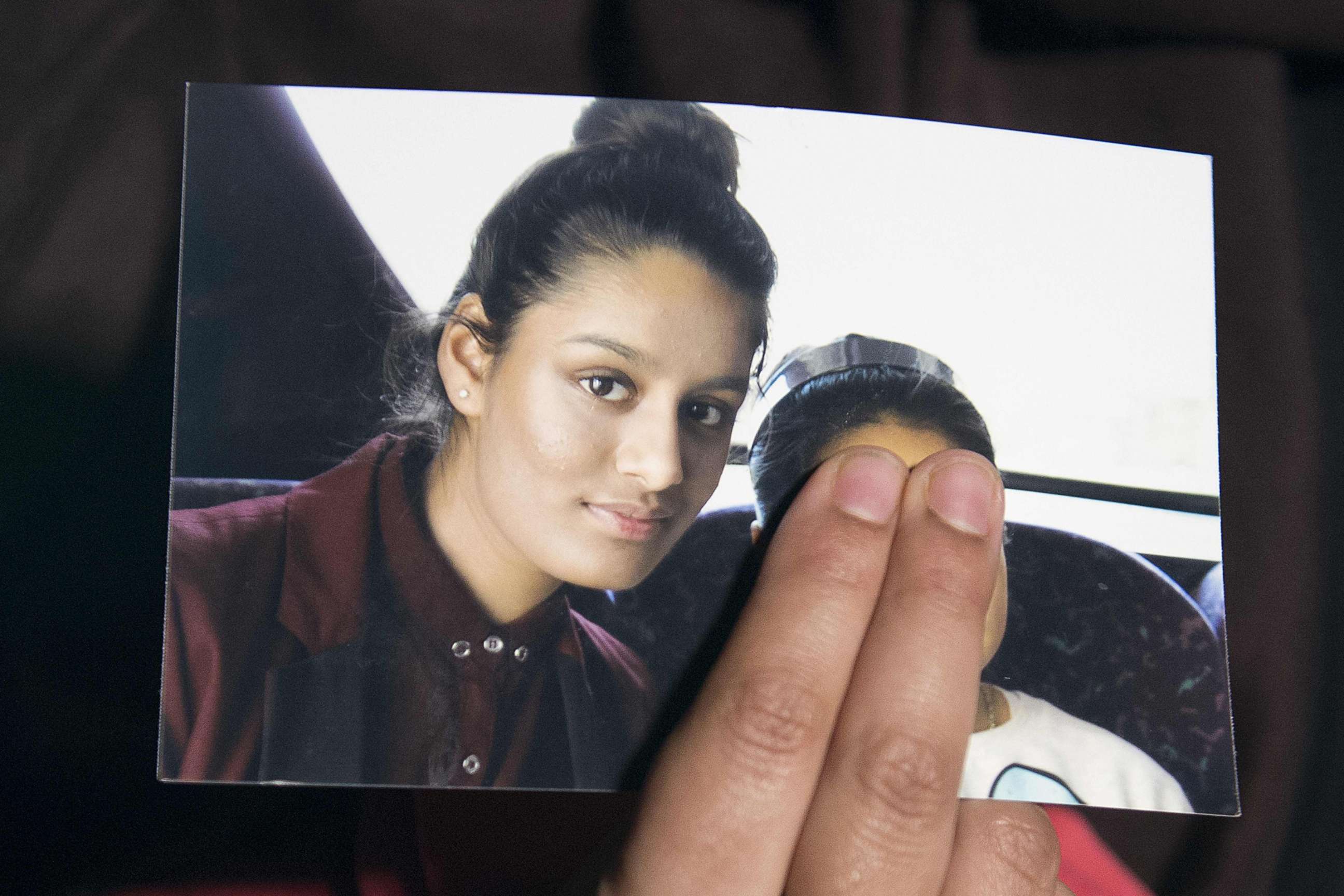 PHOTO: (FILES) In this file photo taken on February 22, 2015 Renu, eldest sister of missing British girl Shamima Begum, holds a picture of her sister while being interviewed by the media in central London, on February 22, 2015. 