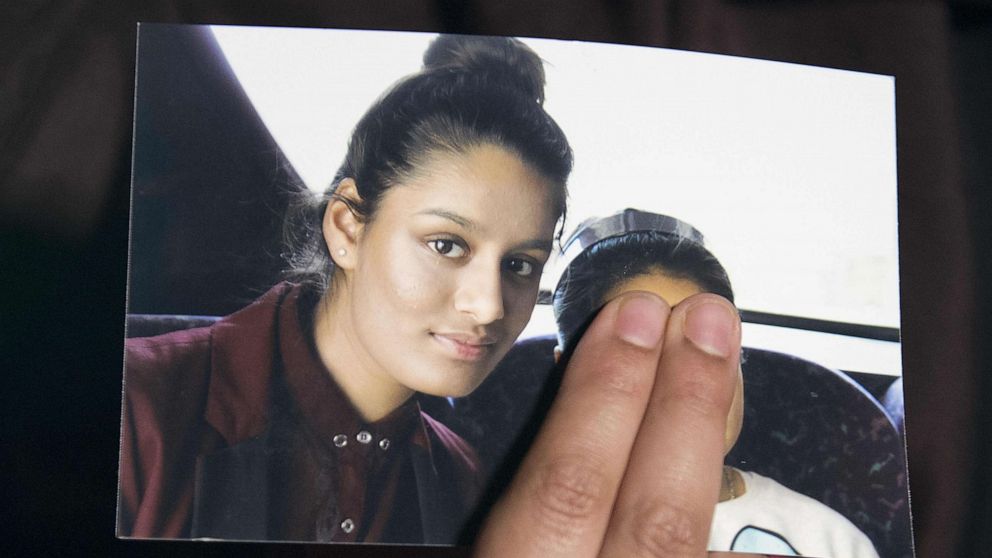 PHOTO: (FILES) In this file photo taken on February 22, 2015 Renu, eldest sister of missing British girl Shamima Begum, holds a picture of her sister while being interviewed by the media in central London, on February 22, 2015. 