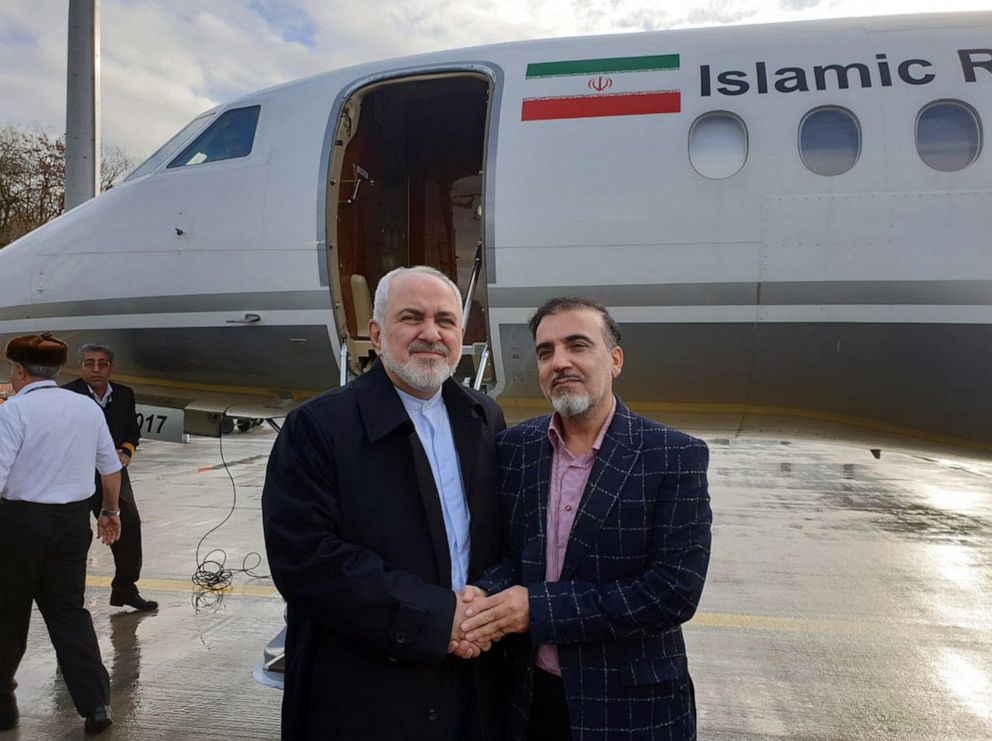 PHOTO: A handout photo made available by Iranian Foreign Affairs Minister Mohammad Javad Zarif's twitter account on December 7, 2019 shows Zarif (L) greeting Iranian researcher Masoud Soleimani at an undisclosed airport in Switzerland.
