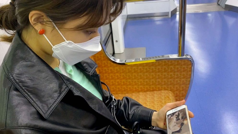 PHOTO: College student Hyun Soo Kim watches 'study with me' YouTube on the subway in Seoul, April 18, 2021.