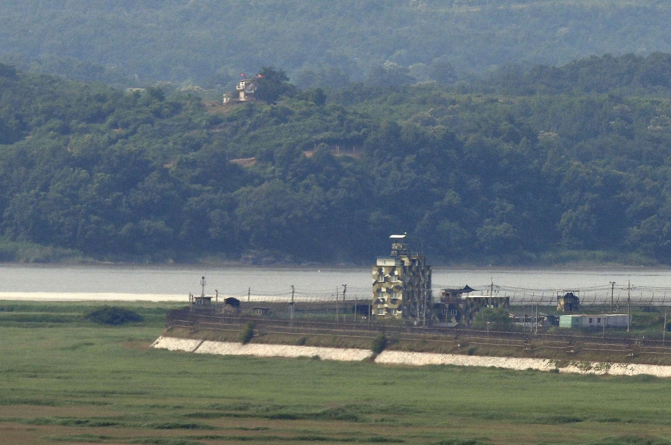 PHOTO: Military guard posts of South Korea (bottom R) and North Korea (top L) stand opposite each other as seen from a South Korean observation post in the border city of Paju on June 17, 2020. 