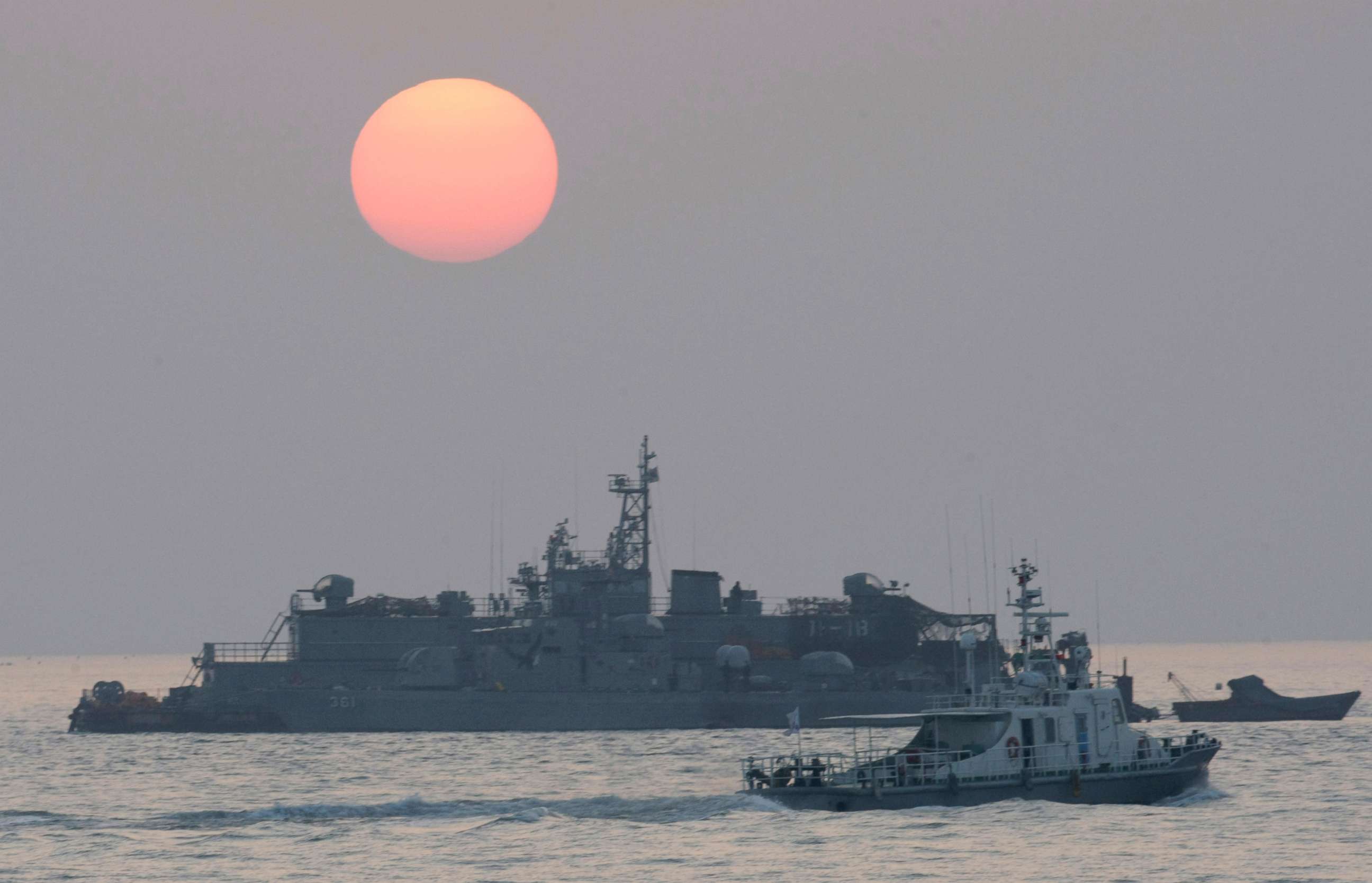 PHOTO: FILE - In this Dec. 22, 2010, file photo, a government ship sails past the South Korean Navy's floating base as the sun rises near Yeonpyeong island, South Korea. 