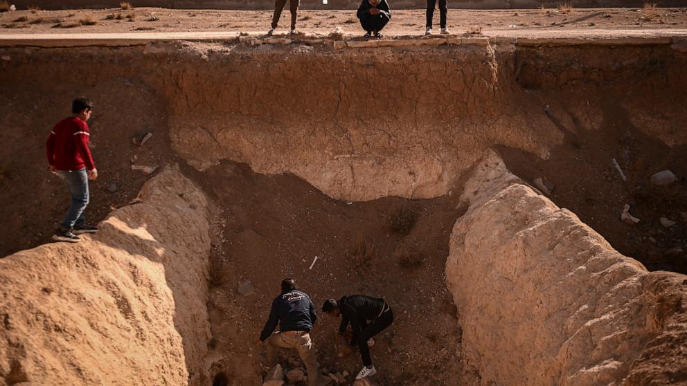 PHOTO: People search for human remains at a trench believed to be used as a mass grave on the outskirts of Damascus, Syria, on Dec. 16, 2024.