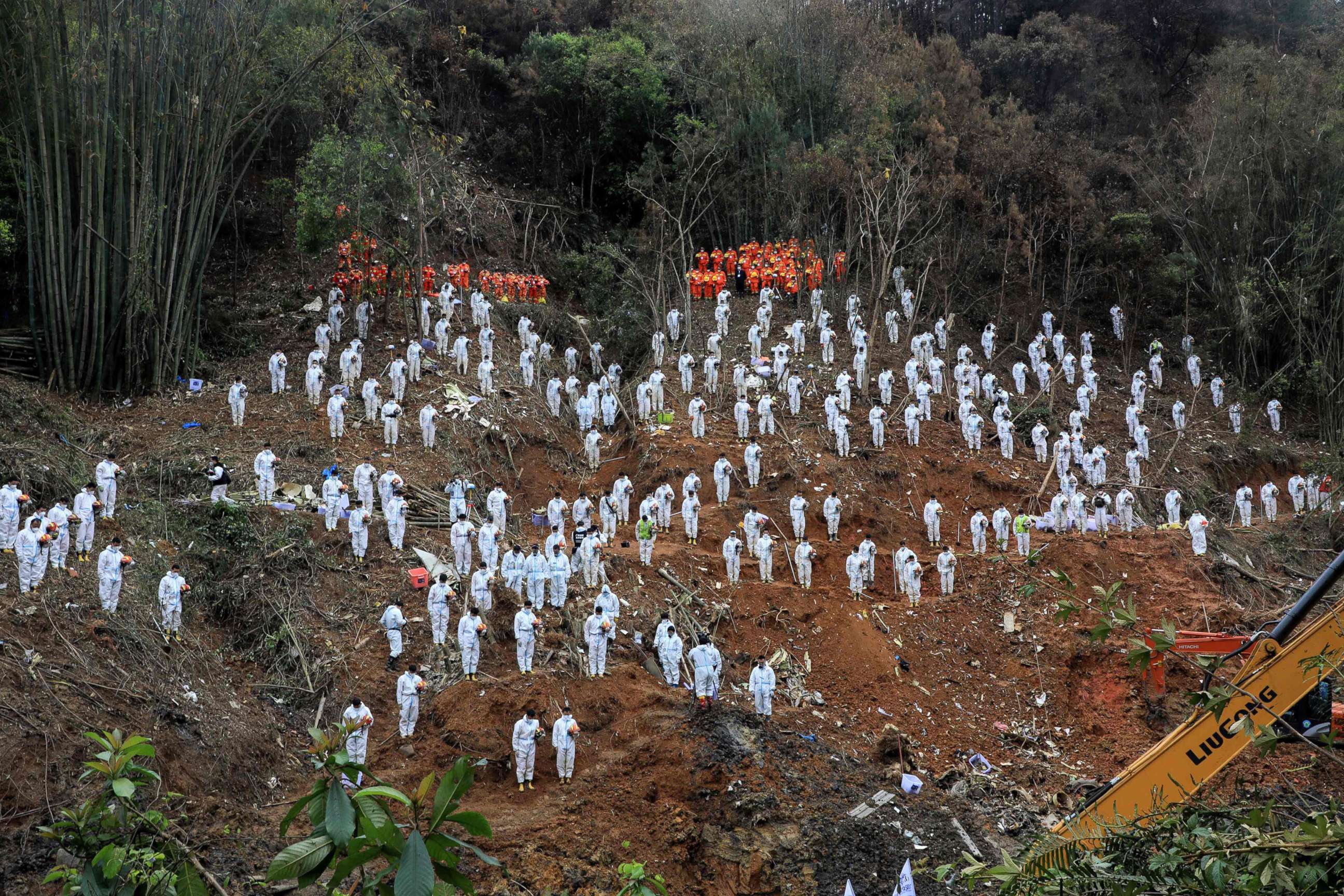 PHOTO: Rescuers stand during a silent tribute for victims at the site of the China Eastern Airlines plane crash, March 27, 2022, in Wuzhou, China. 