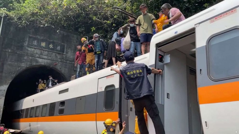 PHOTO: Rescue team help stranded passengers down from the roof of a train which derailed in a tunnel north of Hualien, Taiwan April 2, 2021, in this still image taken from video. 