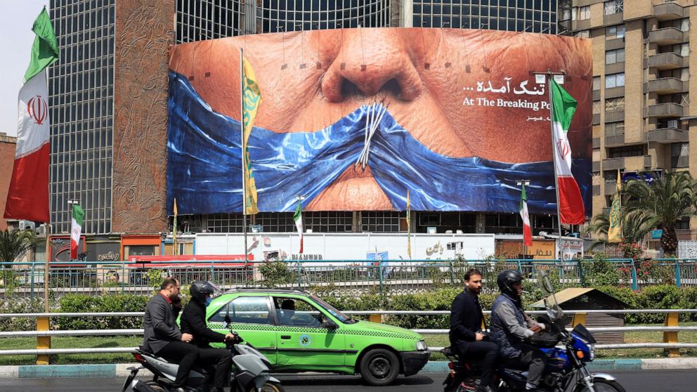 PHOTO: Motorists make their way past an anti-U.S. billboard referring to President Donald Trump and the Strait of Hormuz, in Valiasr Square in Tehran on May 2, 2026.