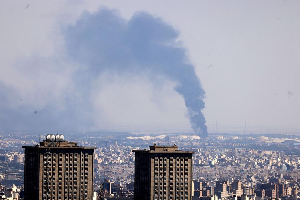 PHOTO: Smoke billows in the distance from an oil refinery following an Israeli strike on the Iranian capital Tehran on June 17, 2025.