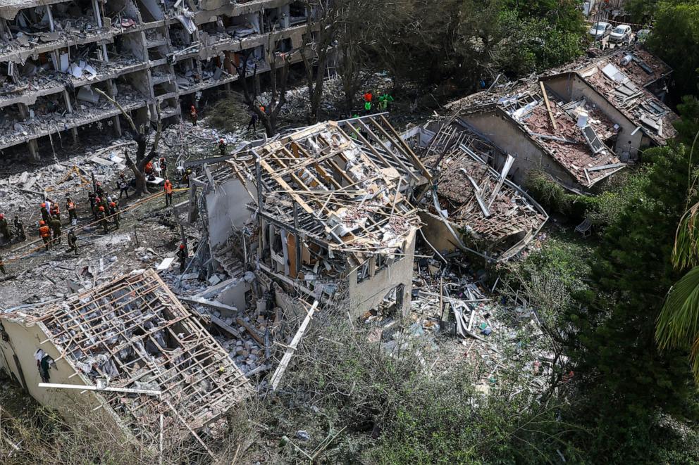 PHOTO: Israeli security forces and first responders gather at the site of an Iranian strike that hit a residential neighbourhood in the Ramat Aviv area in Tel Aviv on June 22, 2025.
