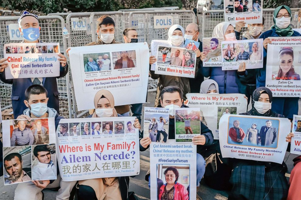 PHOTO: Members of the Muslim Uighur minority hold placards as they demonstrate in front of the Chinese consulate on December 30, 2020, in Istanbul.