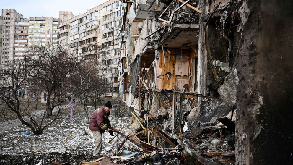 PHOTO: A man clears debris at a damaged residential building at Koshytsa Street, a suburb of the Ukrainian capital Kyiv, where a military shell allegedly hit, Feb. 25, 2022. 