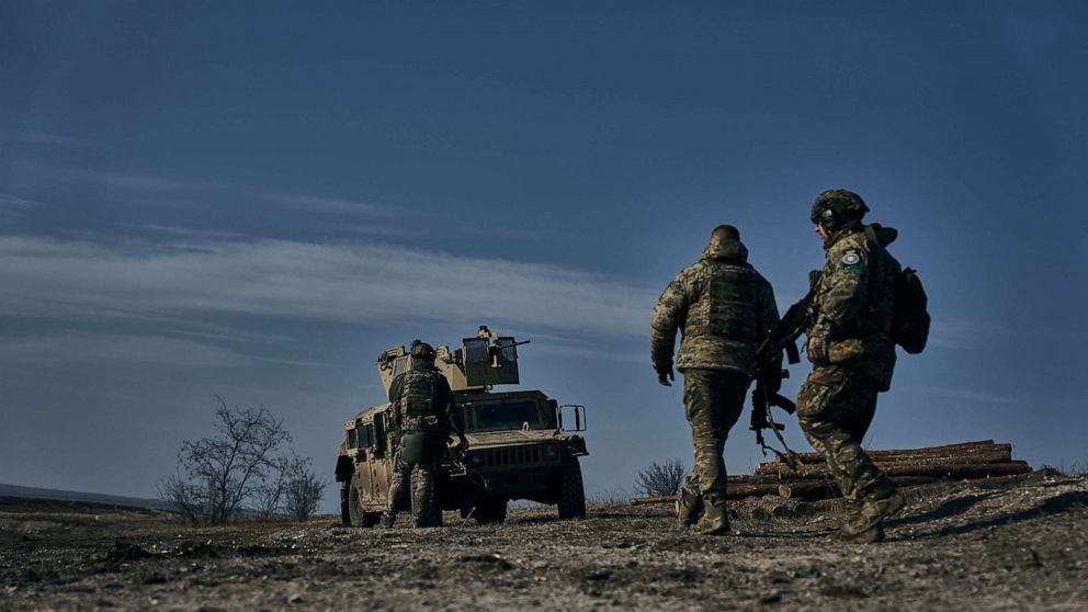 PHOTO: Soldiers of the Ukrainian 3rd Army Assault Brigade of the Special Operations Forces (SSO) "Azov" approach their armoured U.S. Hummer vehicle in position near Bakhmut, Donetsk region, Ukraine, Saturday, Feb. 11, 2023.