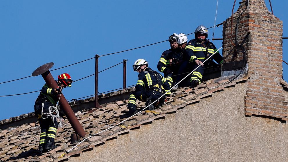 PHOTO: Firefighters install a temporary chimney on the roof of the Sistine Chapel on May 2, 2025 in the Vatican City, used to communicate the choosing of a new pope.