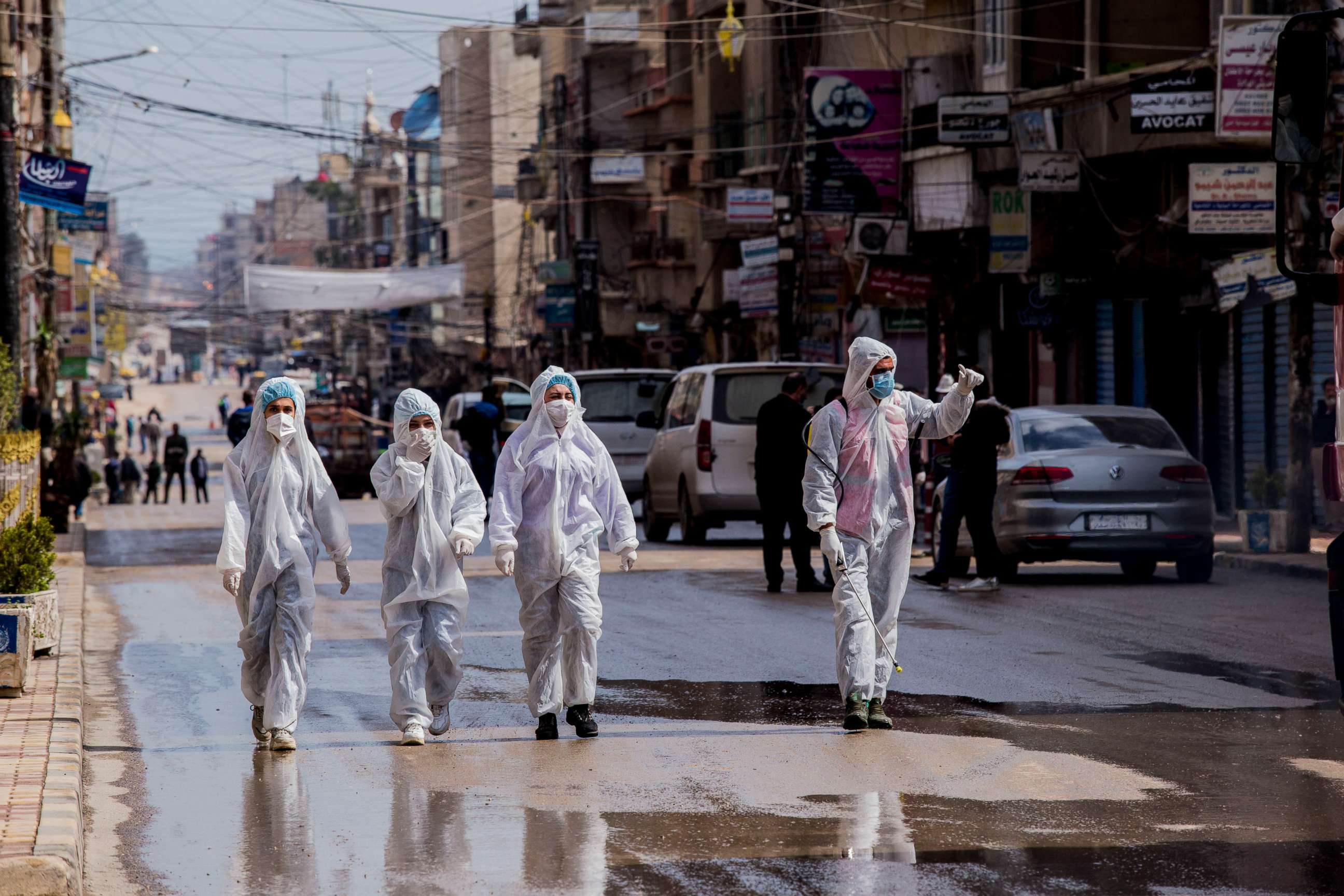 PHOTO: FILE - In this March 24, 2020, file photo, medical workers oversee the disinfection of streets in order to halt the spread of the new coronavirus in Qamishli, Syria. 