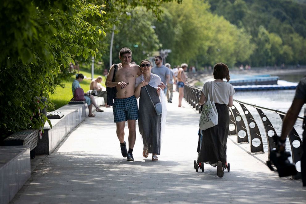 PHOTO: People rest at a one of parks by the Moscow River during a hot day in Moscow, Russia, Tuesday, June 9, 2020. The Russian capital on Tuesday has ended a tight lockdown in place since late March, citing a slowdown in the coronavirus outbreak. 