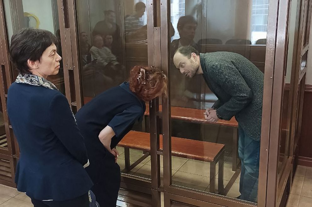 PHOTO: Russian opposition figure Vladimir Kara-Murza, who is accused of treason, talks to his lawyer Maria Eismont from inside a defendants' cage during his sentencing at the Moscow City Court in Moscow, April 17, 2023.
