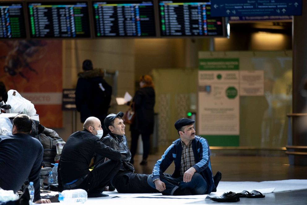 PHOTO: Citizens of Tajikistan rest on the floor waiting for a plane to return in their home country at the Vnukovo International Airport, southwest of Moscow, Russia, on March 24, 2020.